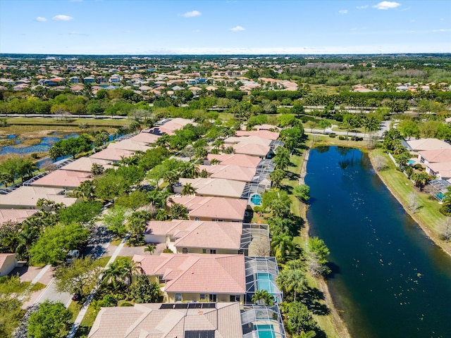 drone / aerial view with a residential view and a water view