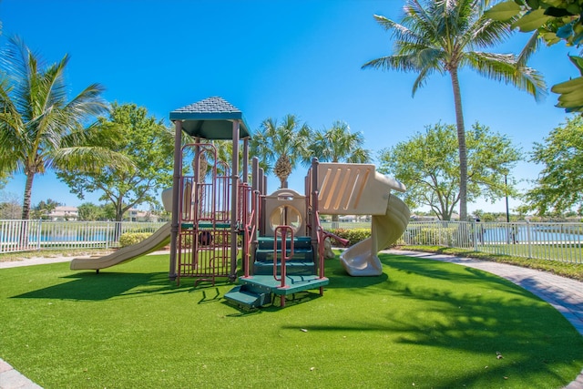 community playground featuring a lawn and fence