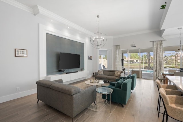 living room featuring a notable chandelier, baseboards, and light wood-style floors