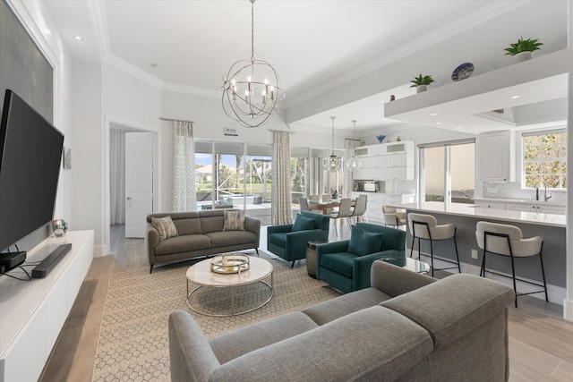 living room with recessed lighting, light wood-style floors, a chandelier, and crown molding