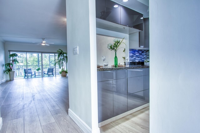 bathroom with backsplash, wood finished floors, and baseboards