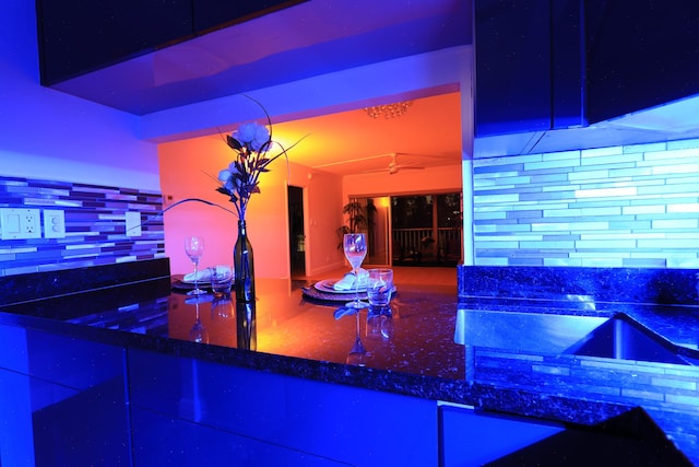 kitchen with a peninsula, tasteful backsplash, appliances with stainless steel finishes, and dark stone countertops