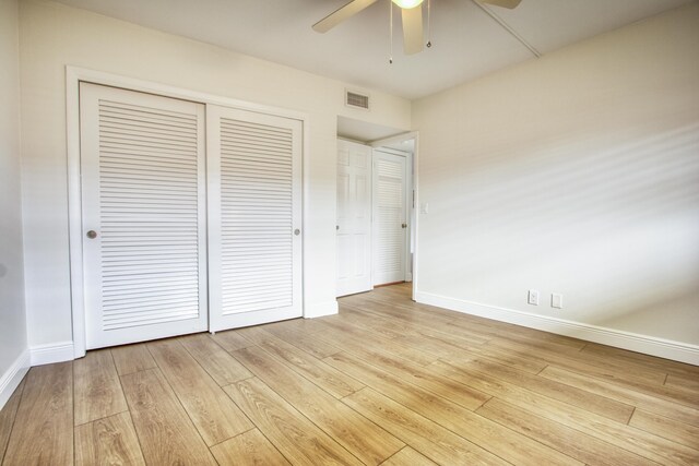 hall featuring light wood finished floors, baseboards, and ornamental molding