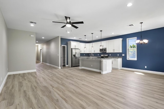 kitchen featuring visible vents, appliances with stainless steel finishes, open floor plan, and ceiling fan with notable chandelier