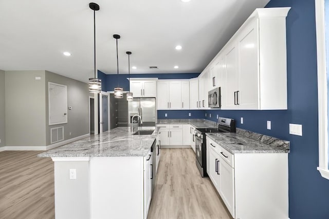 kitchen featuring a sink, visible vents, light wood-style floors, and appliances with stainless steel finishes