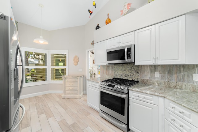 kitchen featuring white cabinetry, light wood finished floors, tasteful backsplash, and appliances with stainless steel finishes