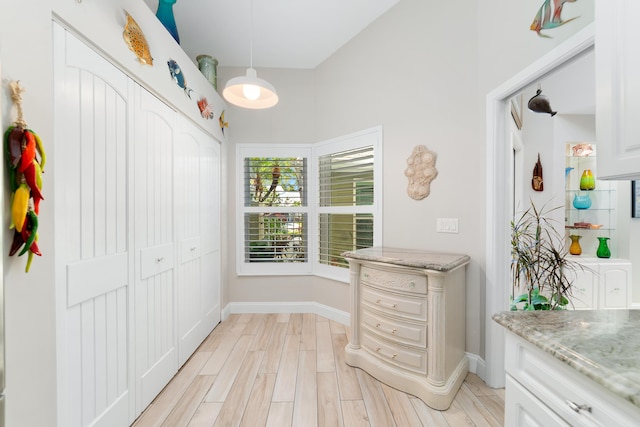 interior space with light wood finished floors and baseboards