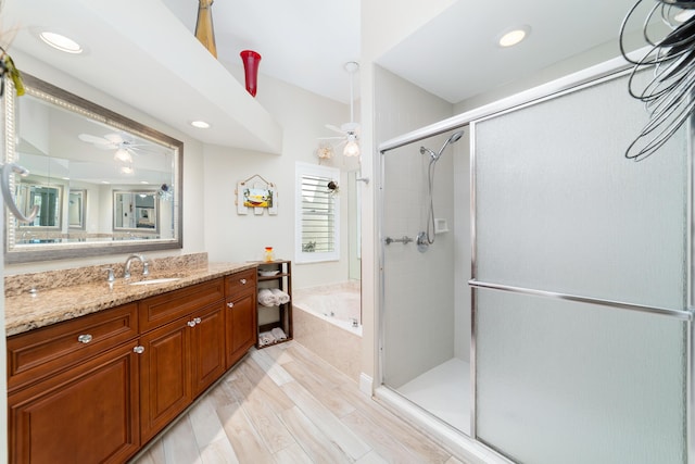 2433 SW Foxpoint Trl, Palm City, FL 34990 - bathroom featuring vanity, a garden tub, a shower stall, a ceiling fan, and recessed lighting