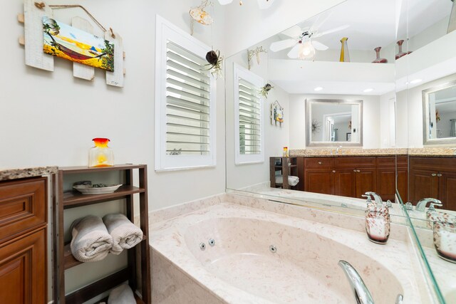 2433 SW Foxpoint Trl, Palm City, FL 34990 - bathroom featuring a jetted tub, vanity, and ceiling fan