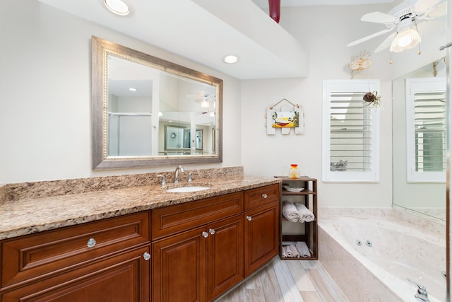 full bathroom with a shower stall, ceiling fan, vanity, and a whirlpool tub