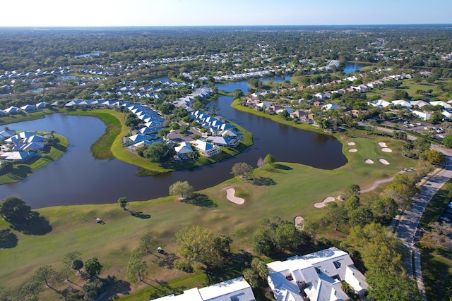 aerial view with view of golf course, a water view, and a residential view