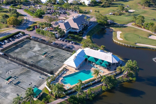 drone / aerial view with golf course view and a water view