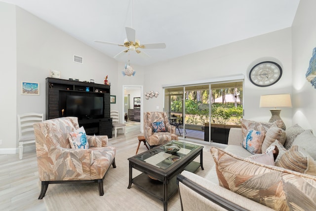 living area with visible vents, light wood-style floors, vaulted ceiling, ceiling fan, and baseboards