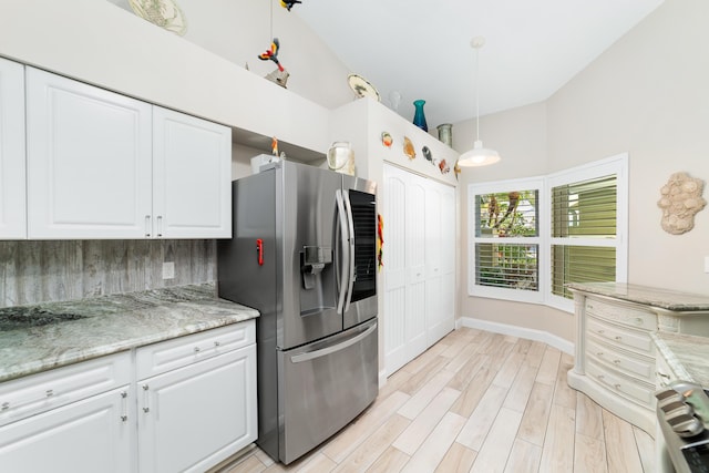 2433 SW Foxpoint Trl, Palm City, FL 34990 - kitchen featuring stainless steel refrigerator with ice dispenser, white cabinets, decorative backsplash, light wood-style floors, and decorative light fixtures