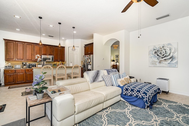 living room with visible vents, arched walkways, a ceiling fan, and recessed lighting