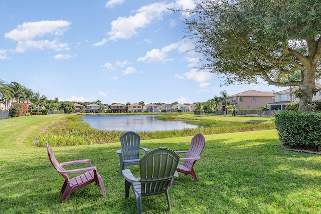 view of yard featuring a residential view and a water view