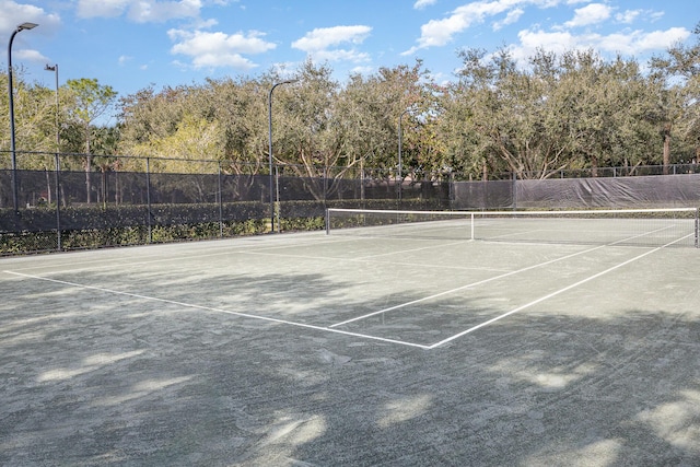 view of tennis court with fence