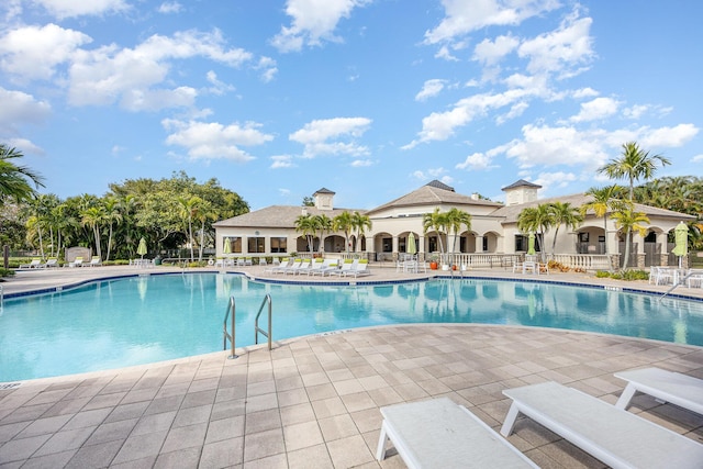 community pool featuring a patio area and fence