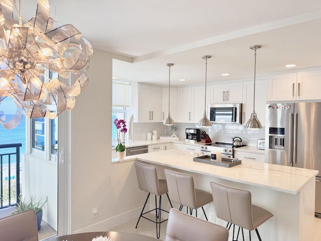 kitchen with tasteful backsplash, high end appliances, and a breakfast bar