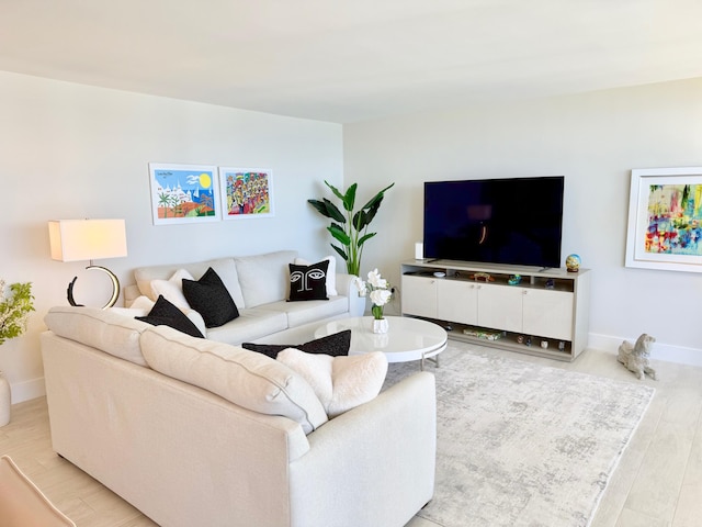 living room featuring baseboards and wood finished floors