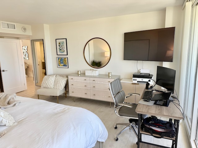 bedroom with light wood-type flooring and visible vents