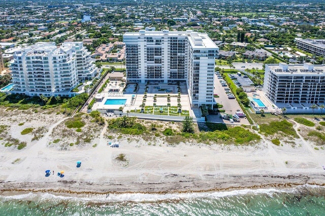 birds eye view of property featuring a view of city and a water view