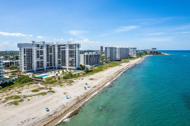 aerial view featuring a view of the beach, a water view, and a city view