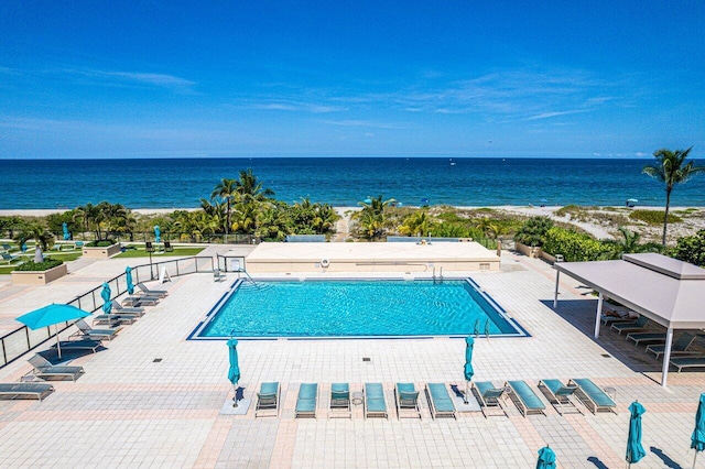 community pool featuring a water view and a patio area