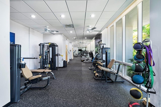 gym featuring a paneled ceiling, visible vents, and a ceiling fan