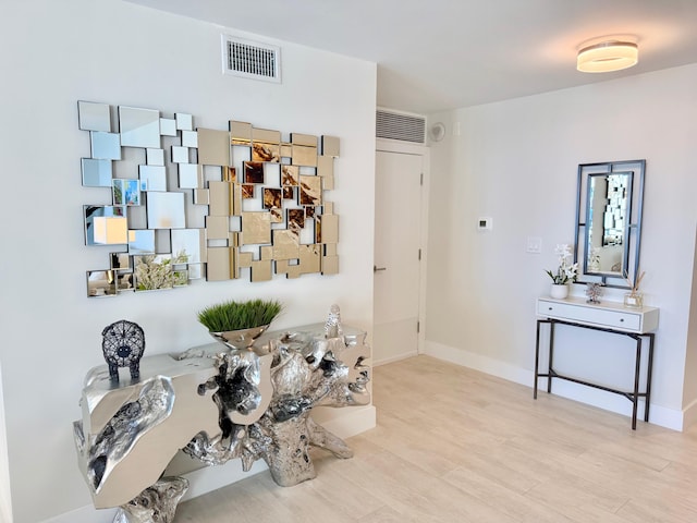 interior space featuring wood finished floors, visible vents, and baseboards