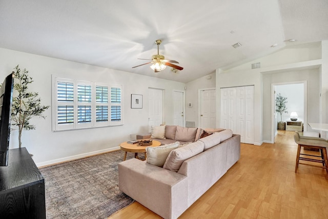 living room featuring visible vents, ceiling fan, lofted ceiling, and light wood-style floors