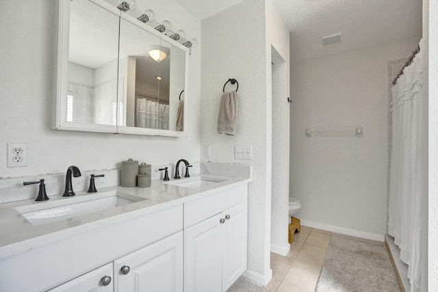 bathroom featuring tile patterned floors, toilet, visible vents, and a sink