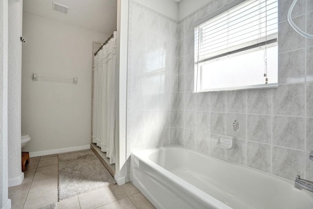 full bathroom featuring tile patterned floors, toilet, baseboards, and visible vents