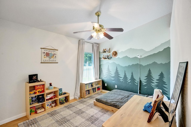 bedroom with baseboards, wood finished floors, and a ceiling fan