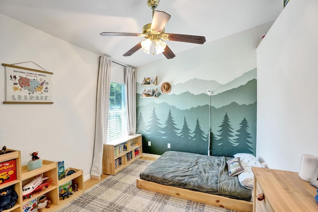 bedroom featuring baseboards, a ceiling fan, and wood finished floors