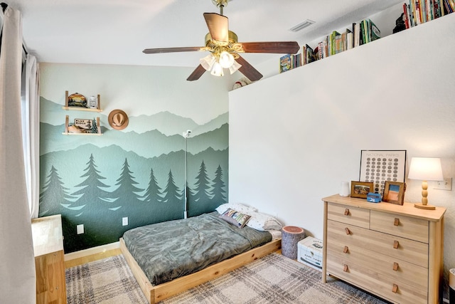 bedroom featuring visible vents, wood finished floors, and ceiling fan