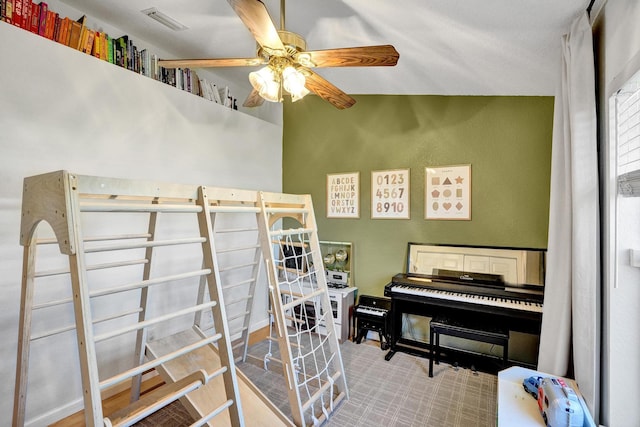 miscellaneous room featuring visible vents and a ceiling fan