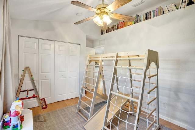 bedroom with visible vents, wood finished floors, a closet, and baseboards