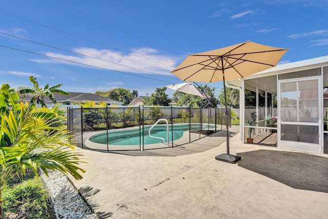 view of swimming pool with a patio area, fence, a fenced in pool, and a sunroom