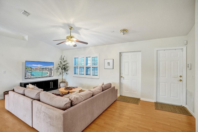 living room with visible vents, baseboards, a ceiling fan, and light wood finished floors