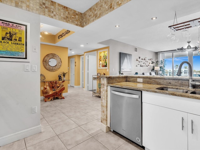 kitchen featuring visible vents, light stone countertops, dishwasher, white cabinets, and a sink