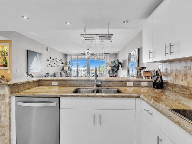 kitchen with a sink, backsplash, light stone countertops, and stainless steel dishwasher