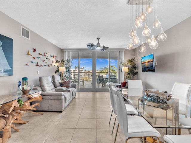 dining space featuring light tile patterned flooring, visible vents, and ceiling fan