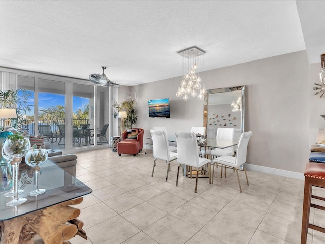 dining area featuring light tile patterned flooring, baseboards, and a textured ceiling