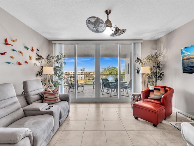 living area with light tile patterned flooring and a textured ceiling