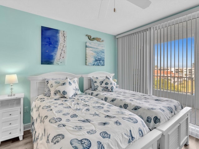 bedroom featuring wood finished floors and a ceiling fan