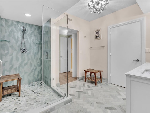 full bath featuring visible vents, baseboards, a stall shower, and vanity