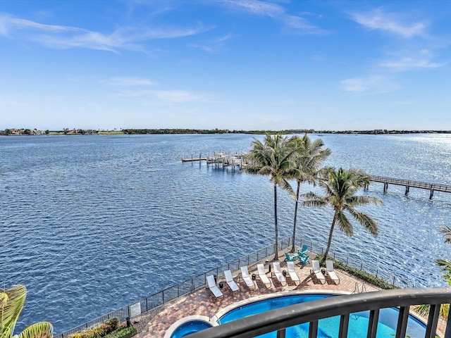 dock area with a community pool and a water view