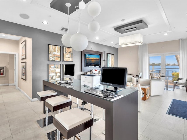 home office featuring visible vents, baseboards, a tray ceiling, light tile patterned floors, and recessed lighting