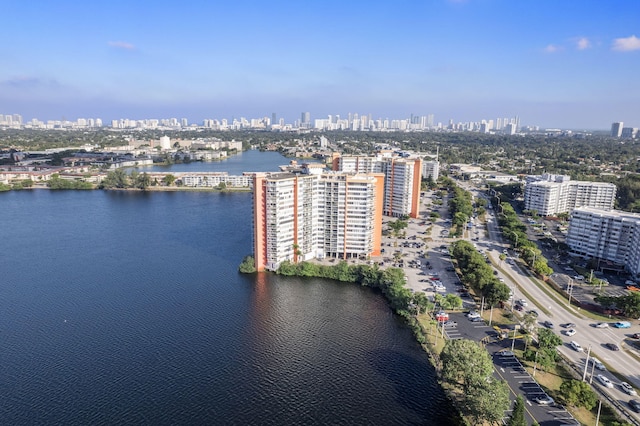 drone / aerial view with a city view and a water view